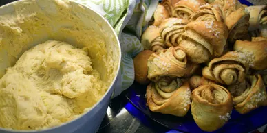 A bowl of kosher dough beside a plate of freshly baked kosher rolls. Richmond Kosher Bakery