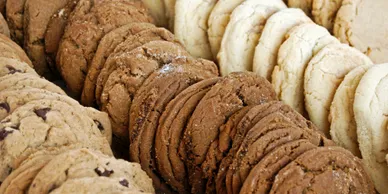 A selection of cookies is displayed on a table at a Kosher Bakery. Richmond Kosher Bakery
