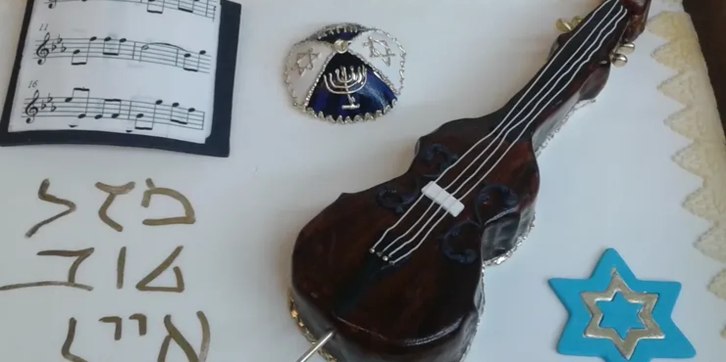 A Kosher Bakery offers a cake adorned with a violin and Star of David decoration. Richmond Kosher Bakery